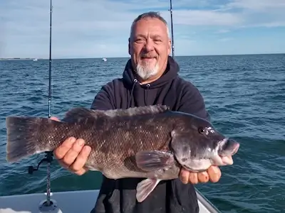 Angler shows off nice tog.