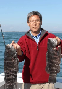 Fish Trap client scores two nice big togs on his RI inshore charter trip.