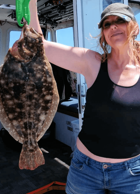 Lady angler with a really nice flounder.