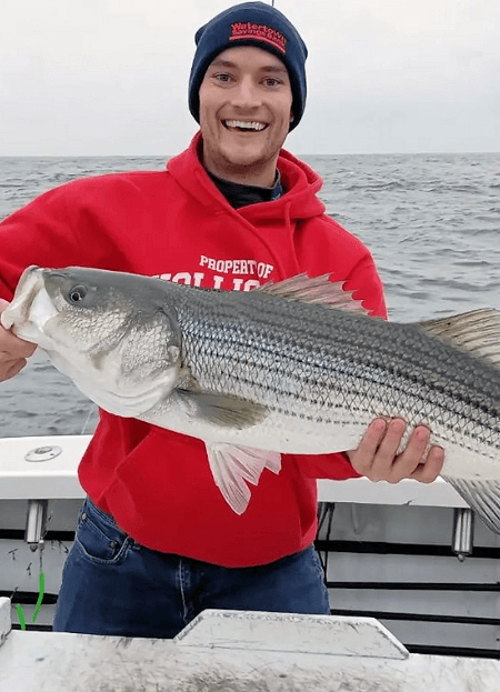 Happy Black Island angler holding up a big striper.